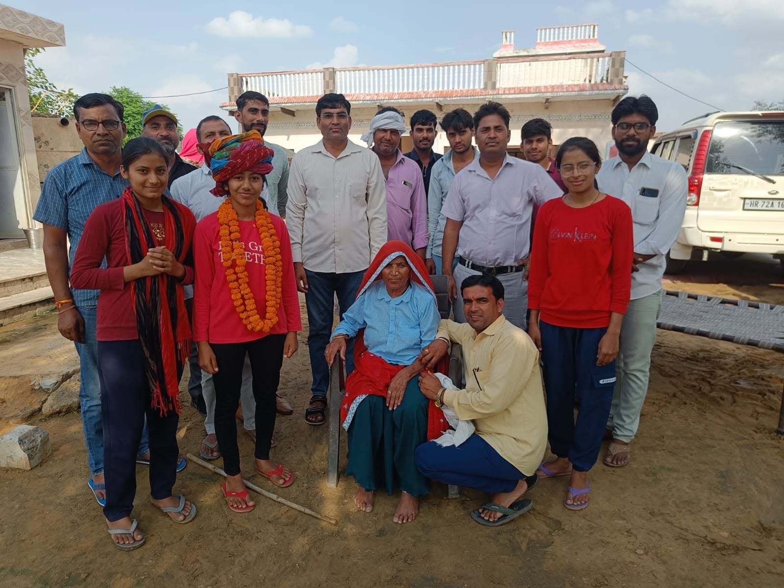 Jyoti Public Senior Secondary School students celebrating an achievement with family, teachers, and community members